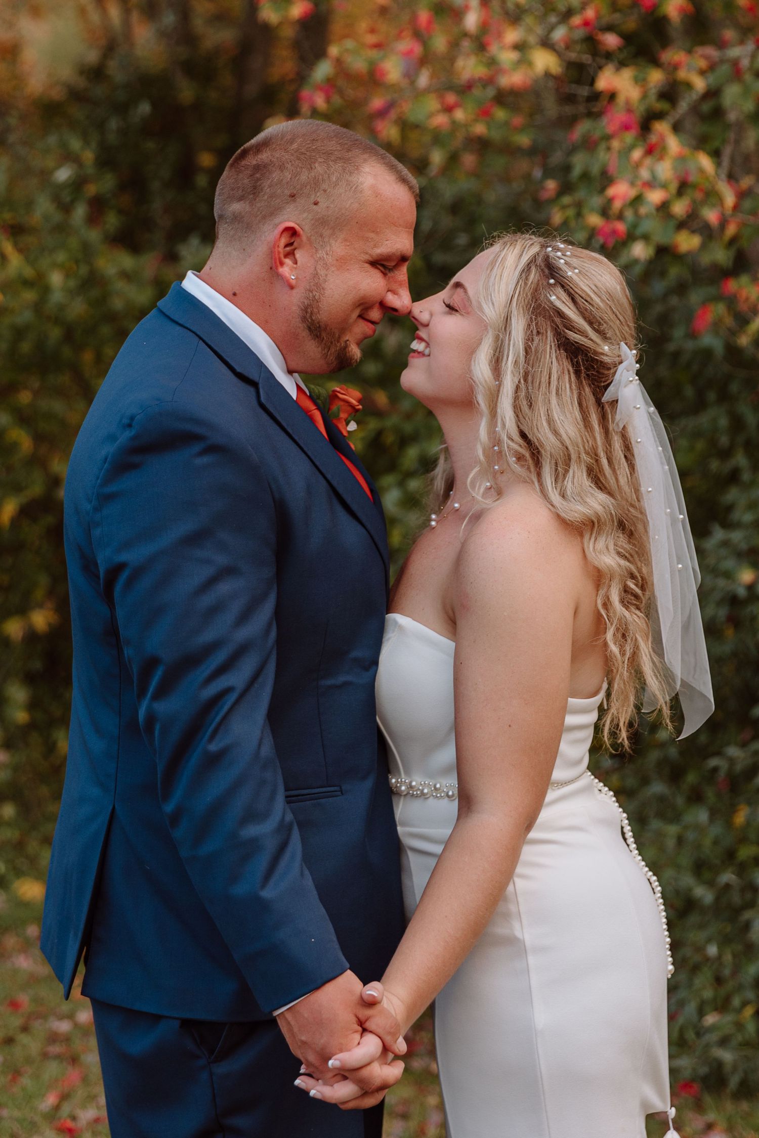 Connecticut Couple just married at Sweet Hill Farm holding hand and touching noses