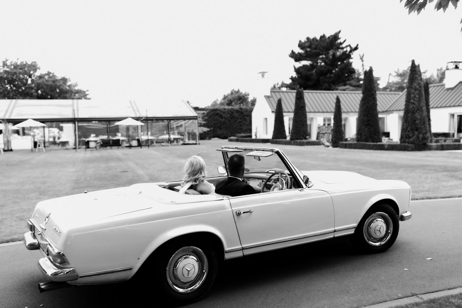 Vintage black and white photo of classic Mercedes-Benz 280SL Pagoda convertible.