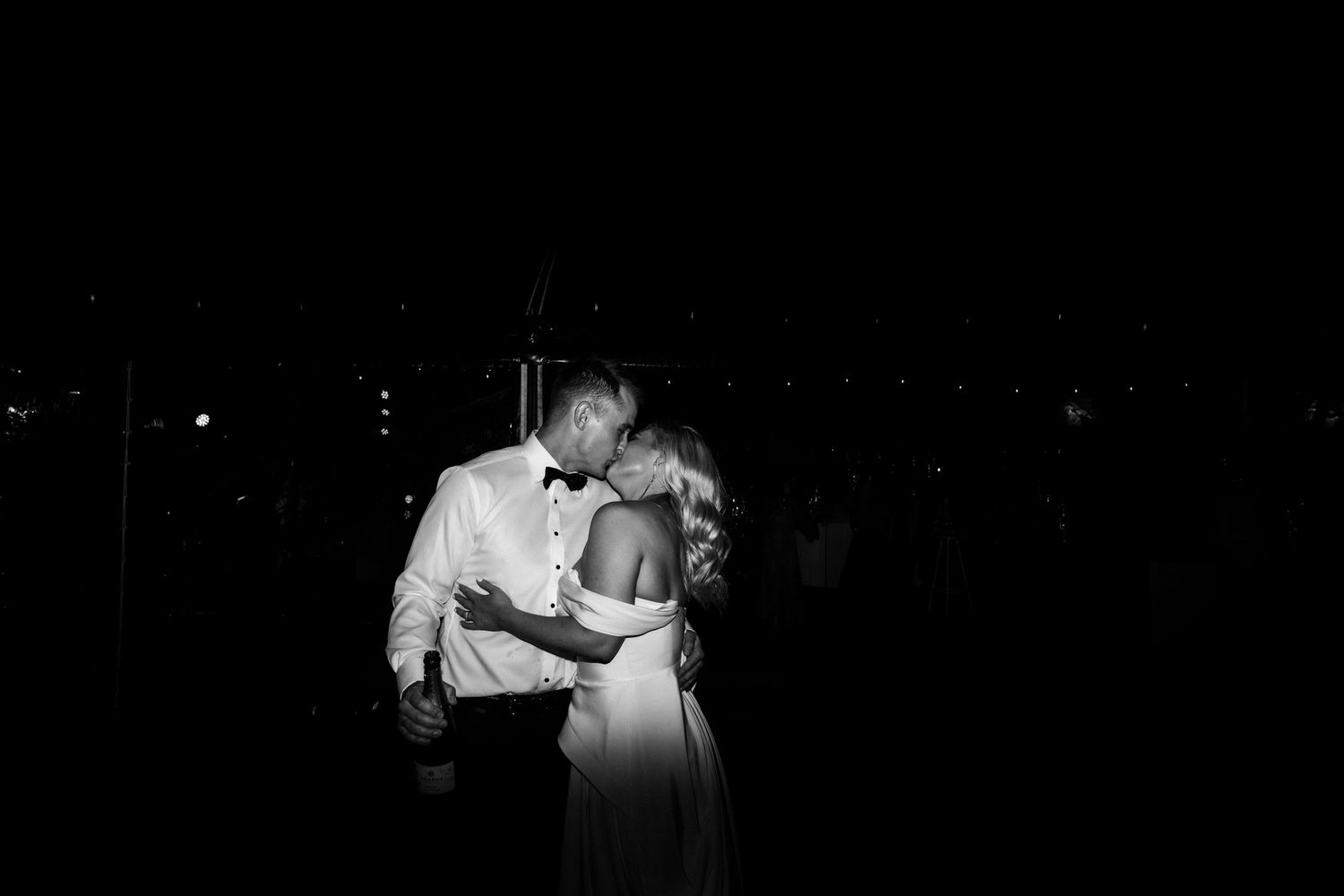 An intimate slow dance moment captured in dramatic black and white photography.
