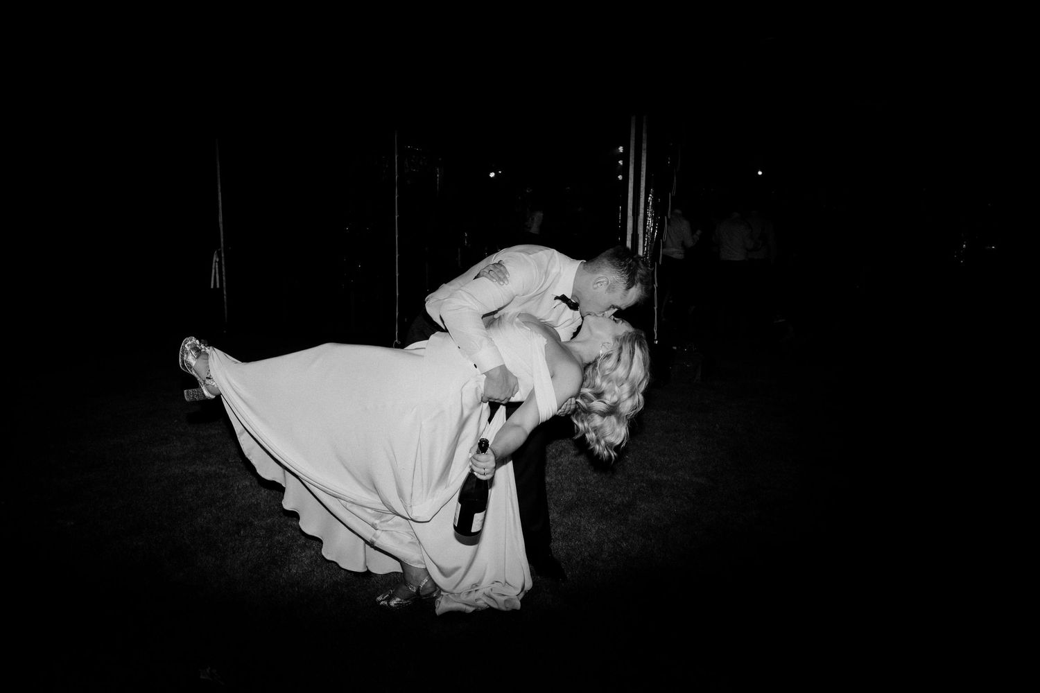 A dramatic dip pose during a wedding dance captured in black and white.