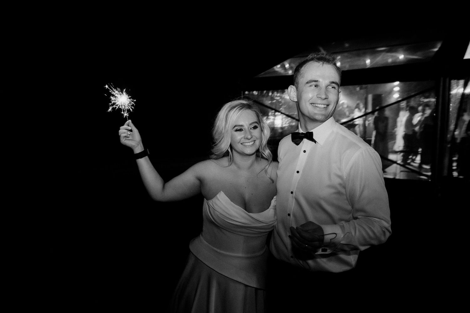 A festive celebration moment with sparklers at a nighttime event.