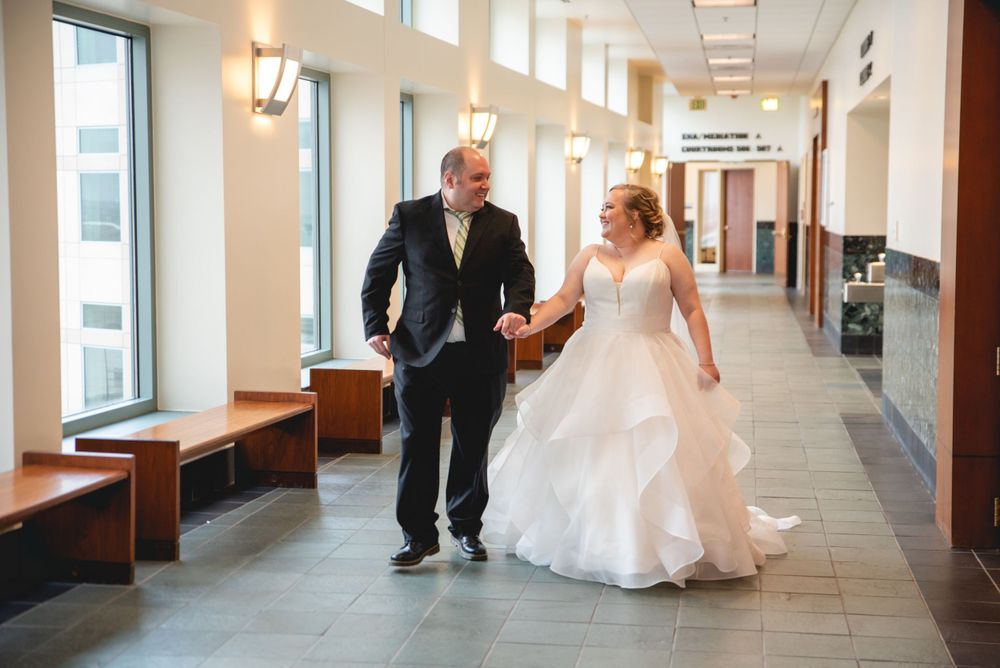bride and groom, walking down hallway in courthouse