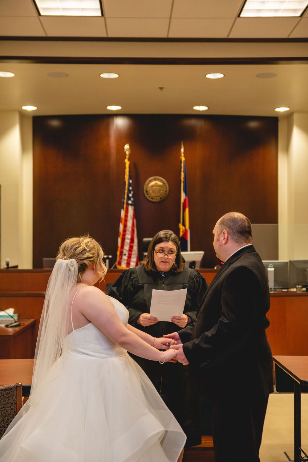 bride and groom listening to judge while getting married