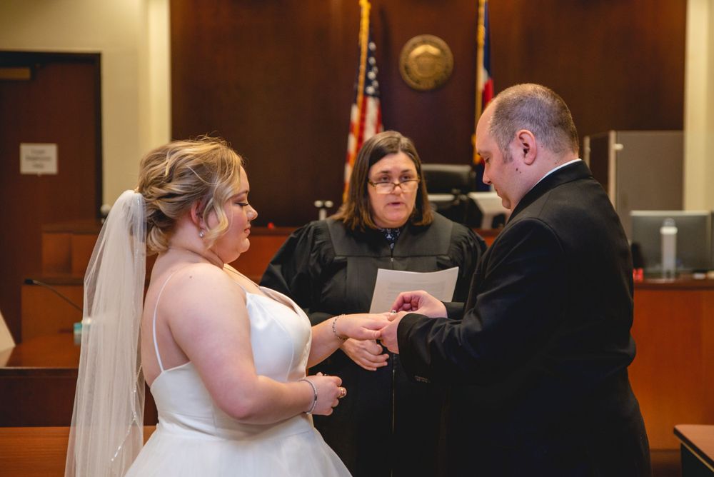 groom giving bride wedding ring