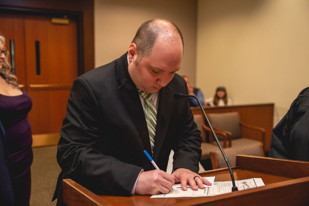 groom signing marriage license