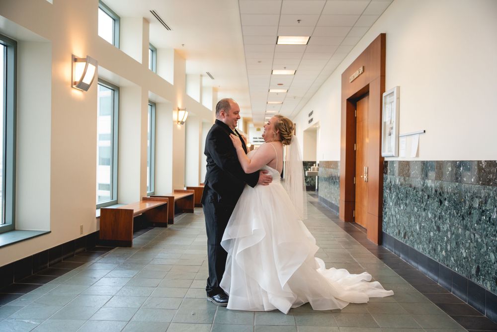 bride and groom in hallway of courthouse