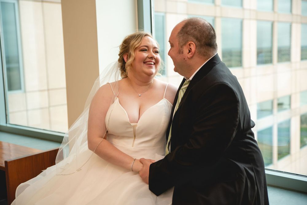bride and groom sitting on bench in courthouse