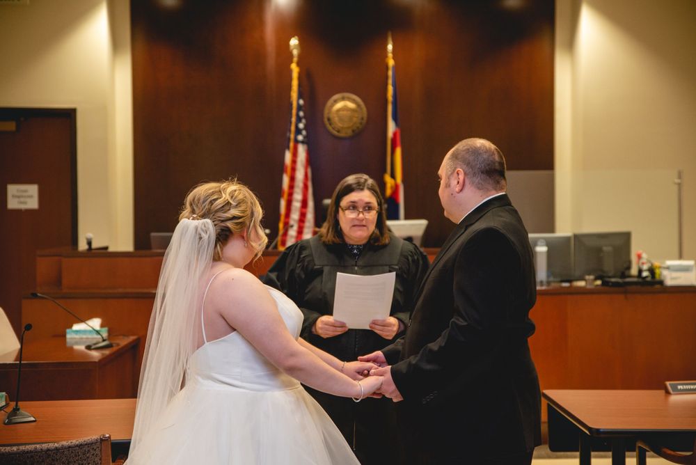 bride and groom holding hands during ceremony