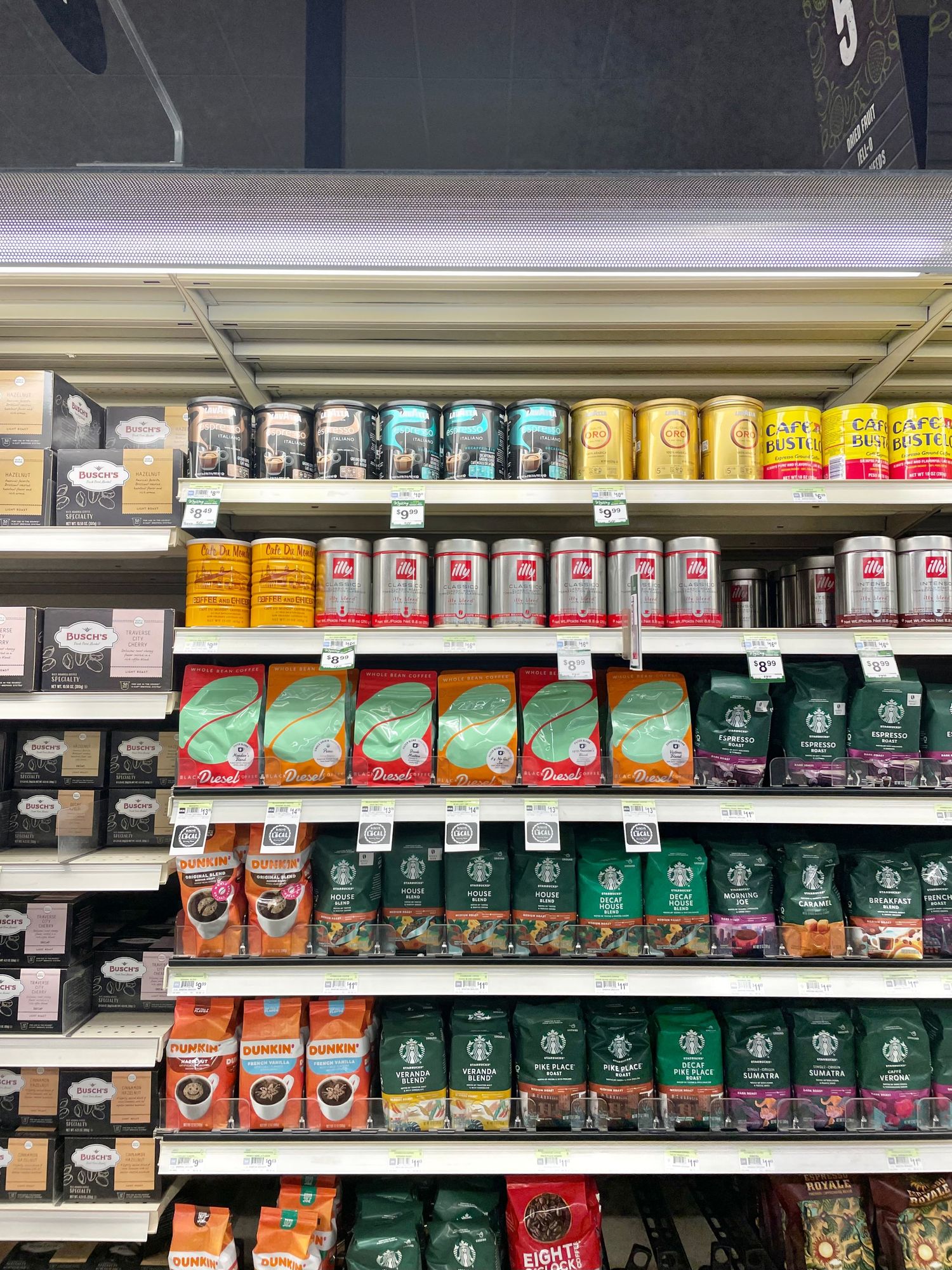 Retail shelf display of various coffee and tea products in grocery store.