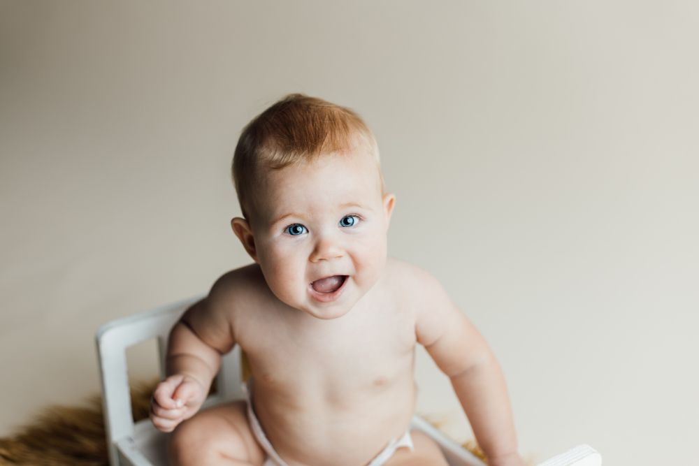 Studio milestone session with bed prop and little boy in Concordia Kansas
