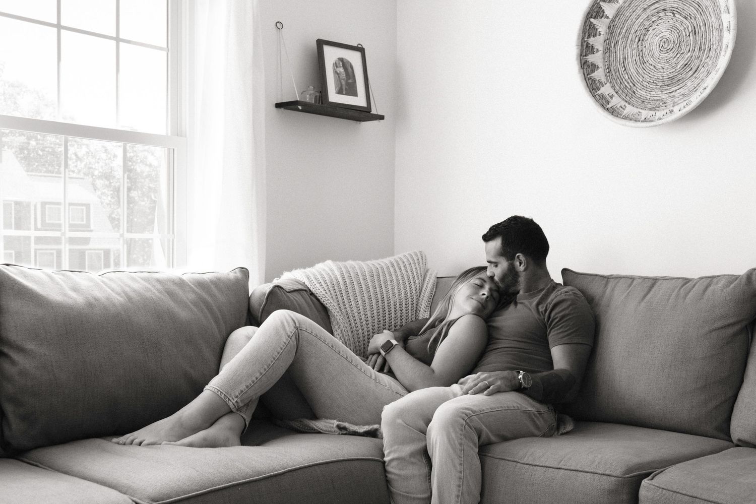 couple lounging on couch kissing forehead