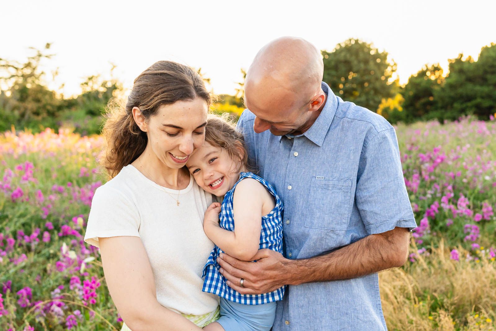 Parents hugging their daughter among the sweet peas at Discovery Park.