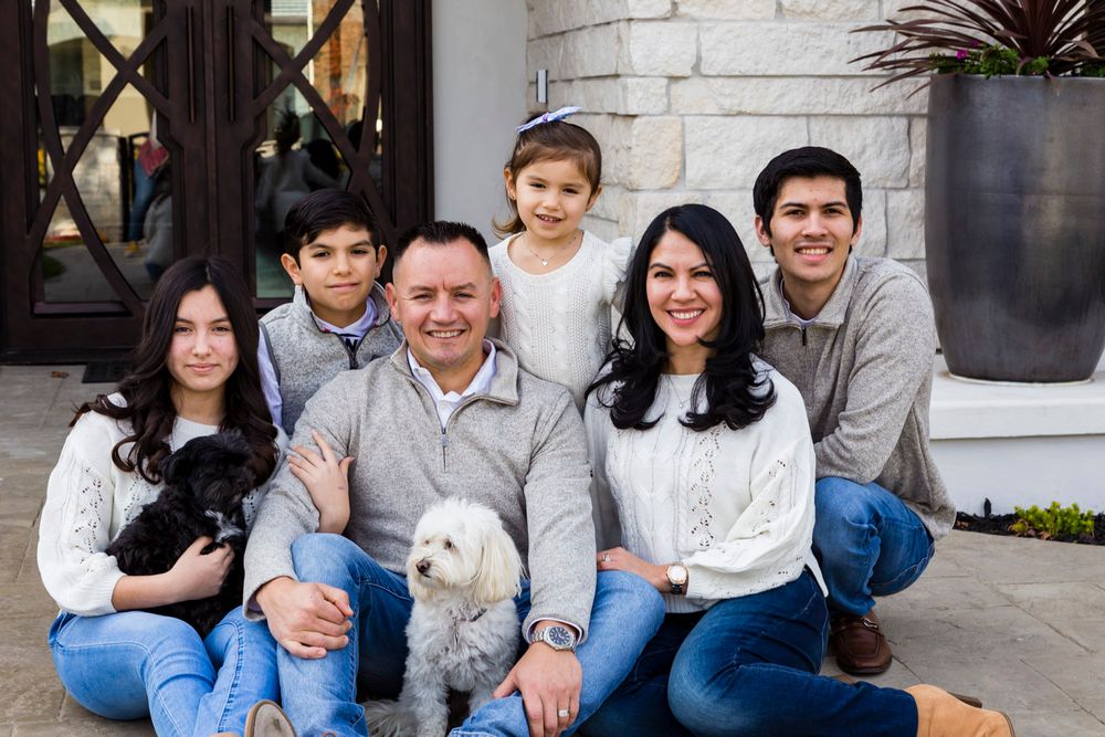 family in front of house