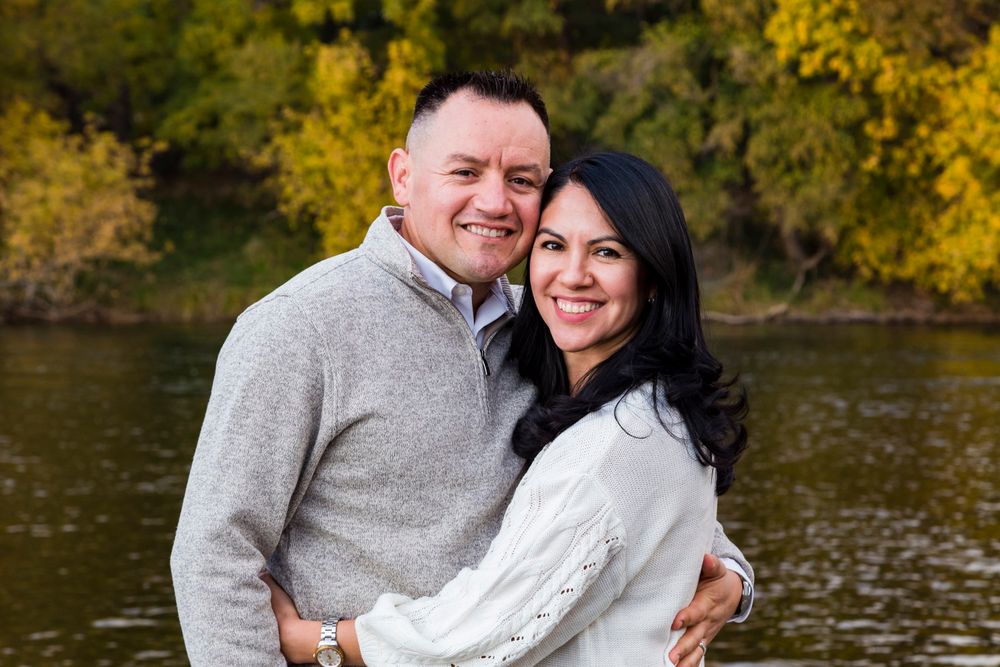 couple on the river shore in the fall