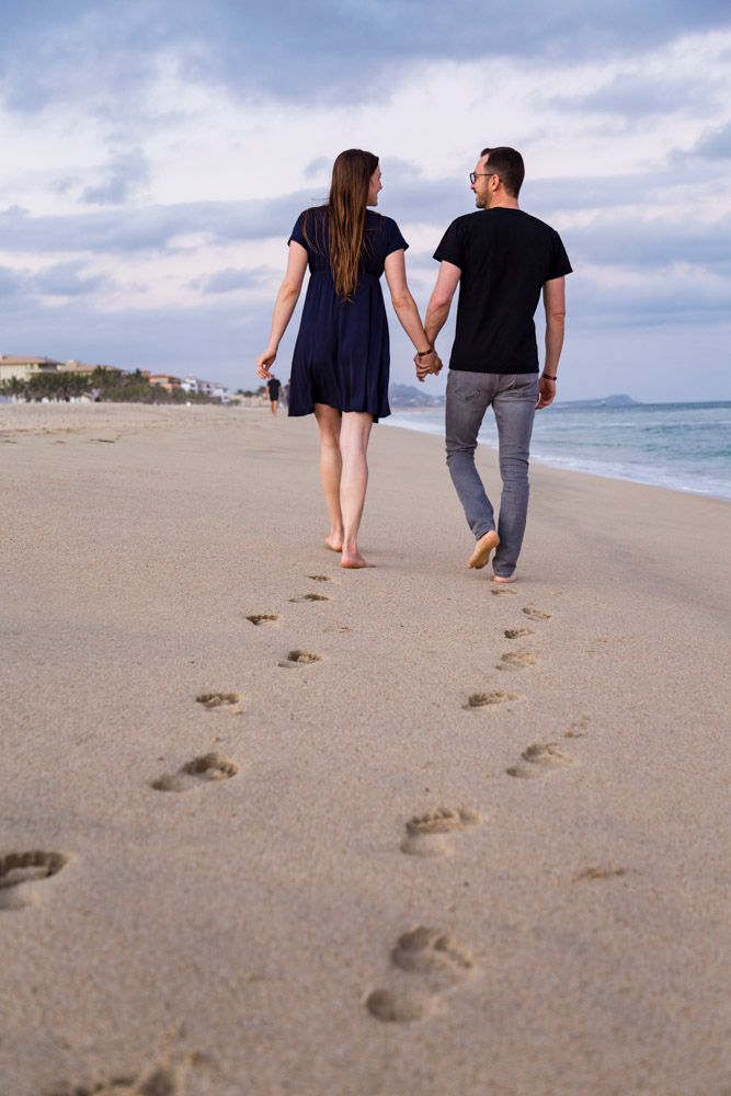 couple walking closely to each other on the beach in San Jose del Cabo, Baja Mexico