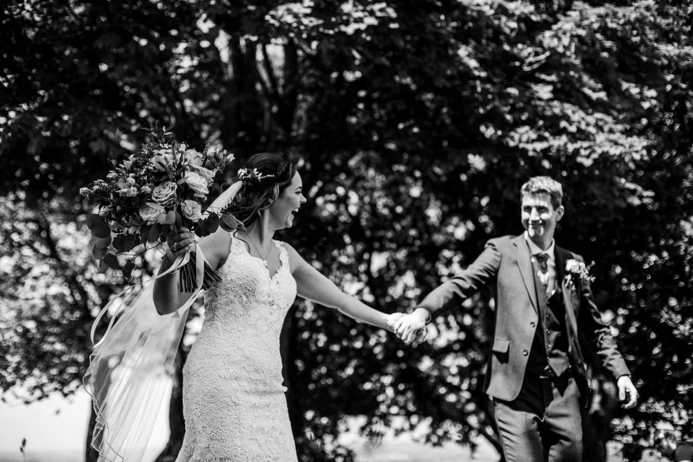 Joyful moment captured during outdoor wedding celebration.