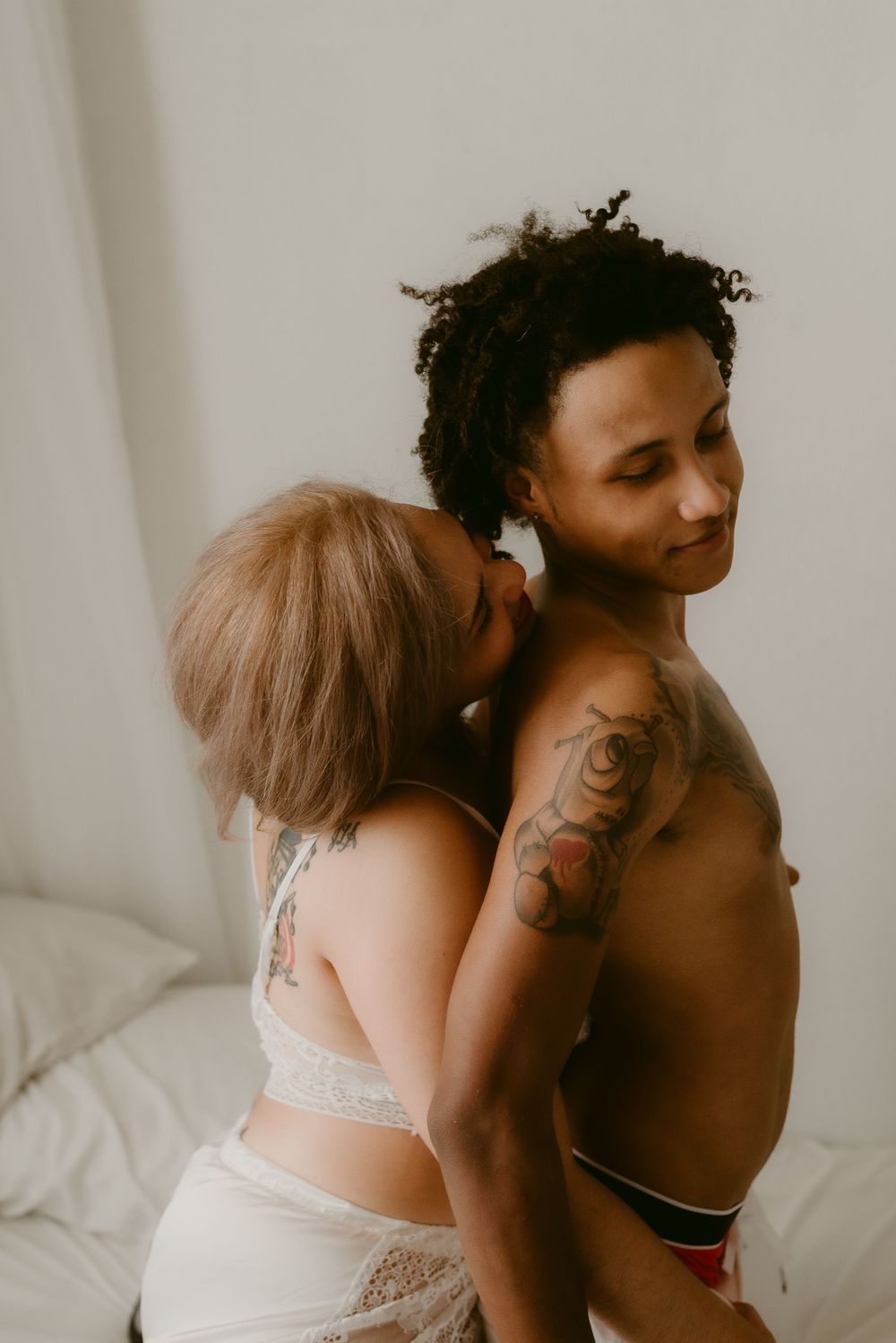 Intimate couple's photoshoot featuring soft lighting and natural poses.