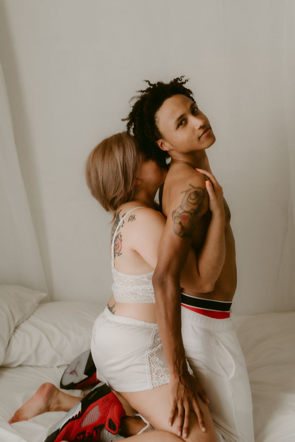 Intimate couple's portrait showing connection and tenderness in soft lighting.