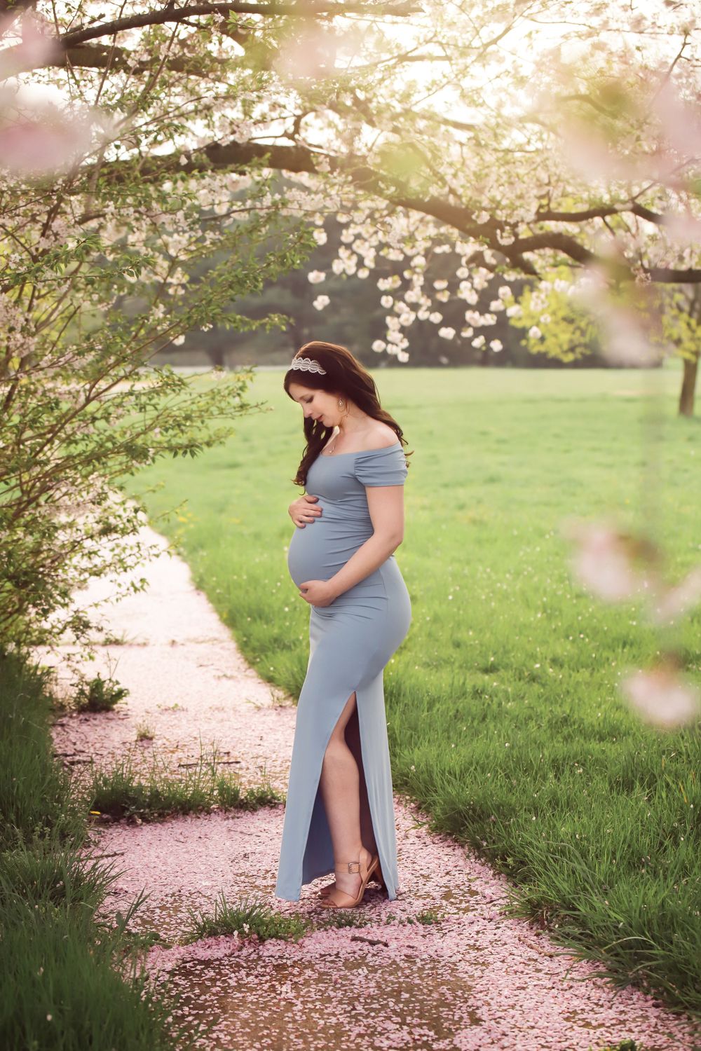 Fine art outdoor maternity portrait in Spring with long dress and flowers