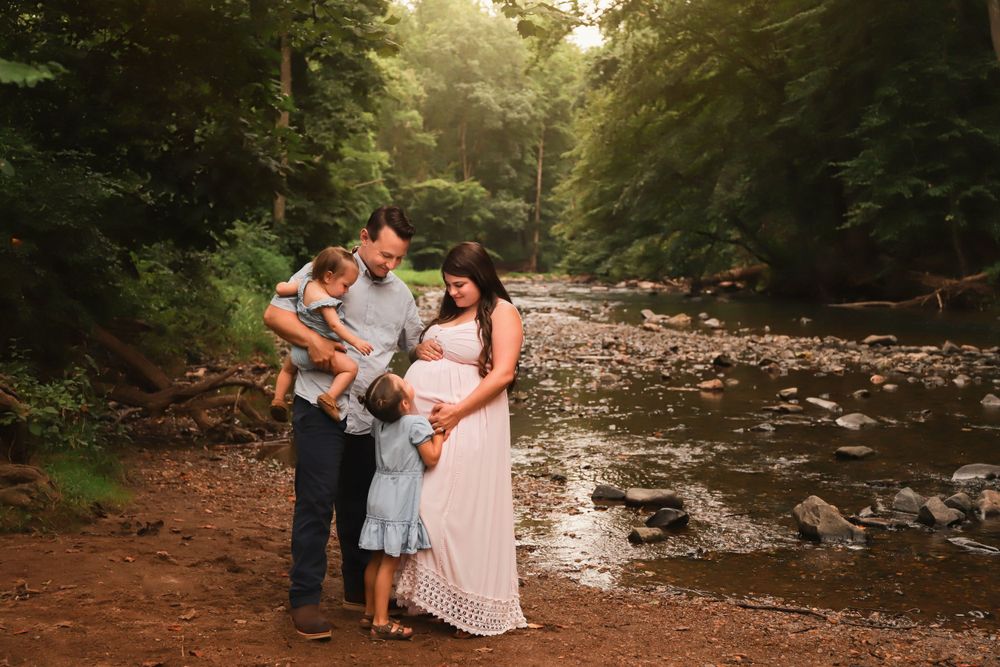 Fine art outdoor maternity portrait with family in Summer at the creek
