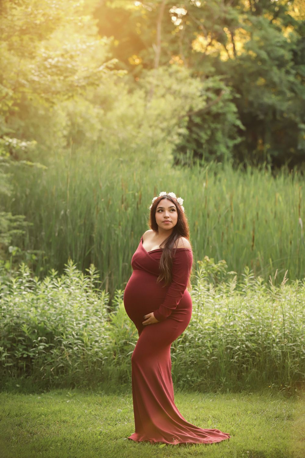 Fine art outdoor maternity portrait in Summer with long dress and flower crown