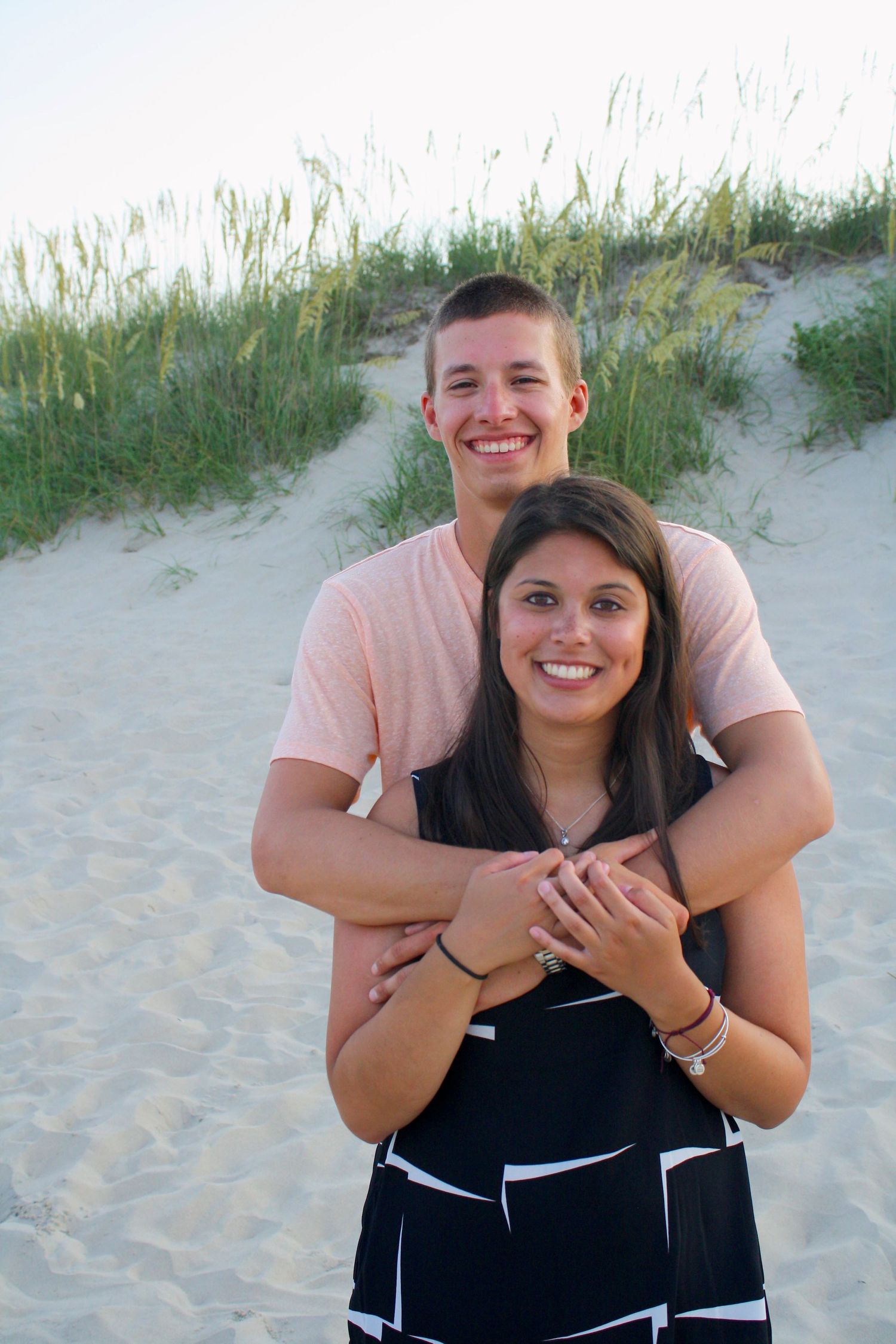Couple posing on a Beach with Sand dunes in the Background