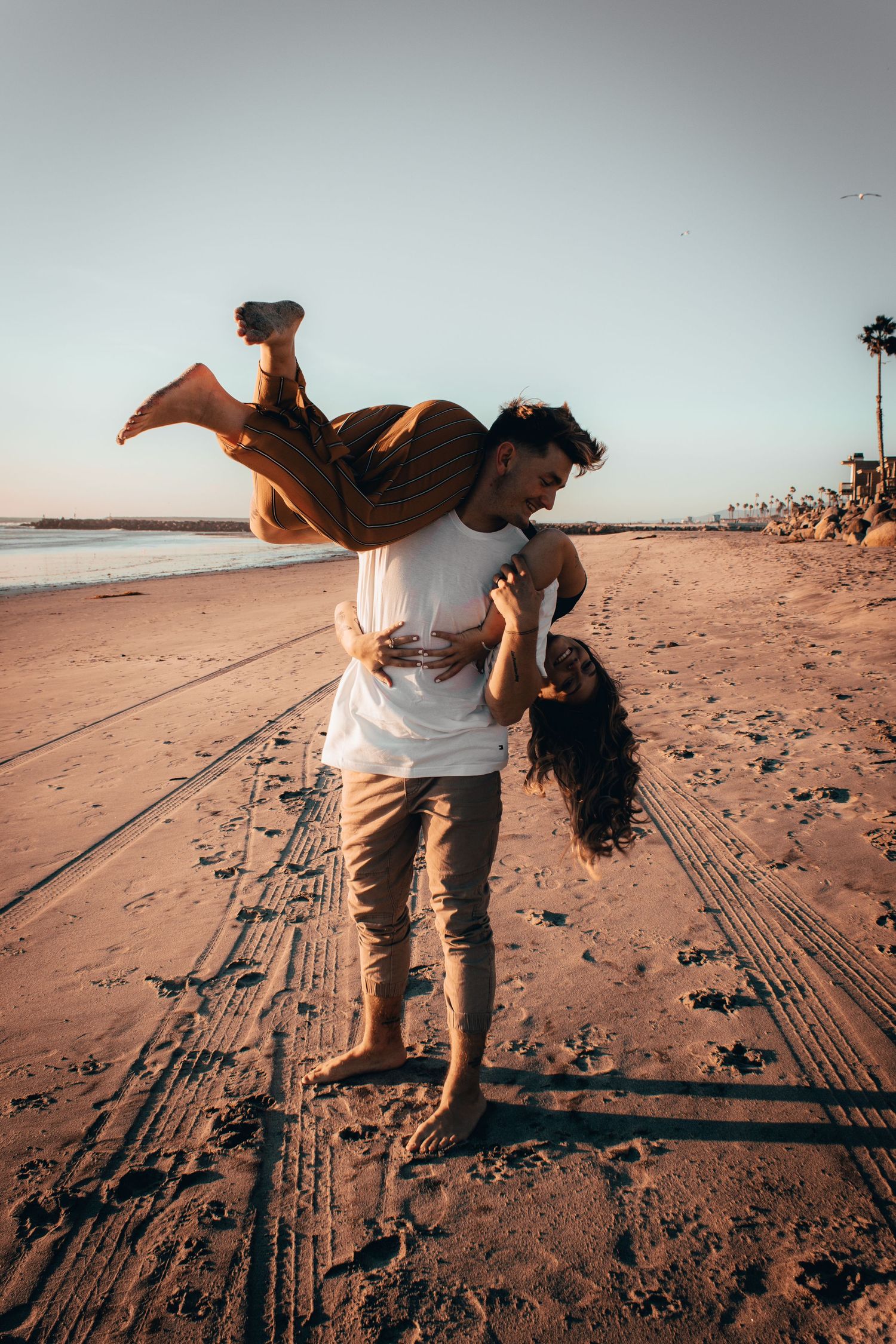 Couple posing on the beach in oceanside, ca