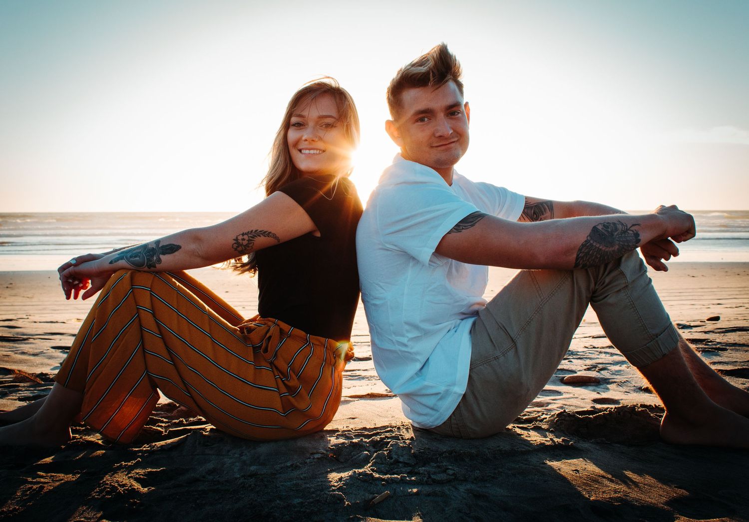 Couple posing on the beach in oceanside, ca