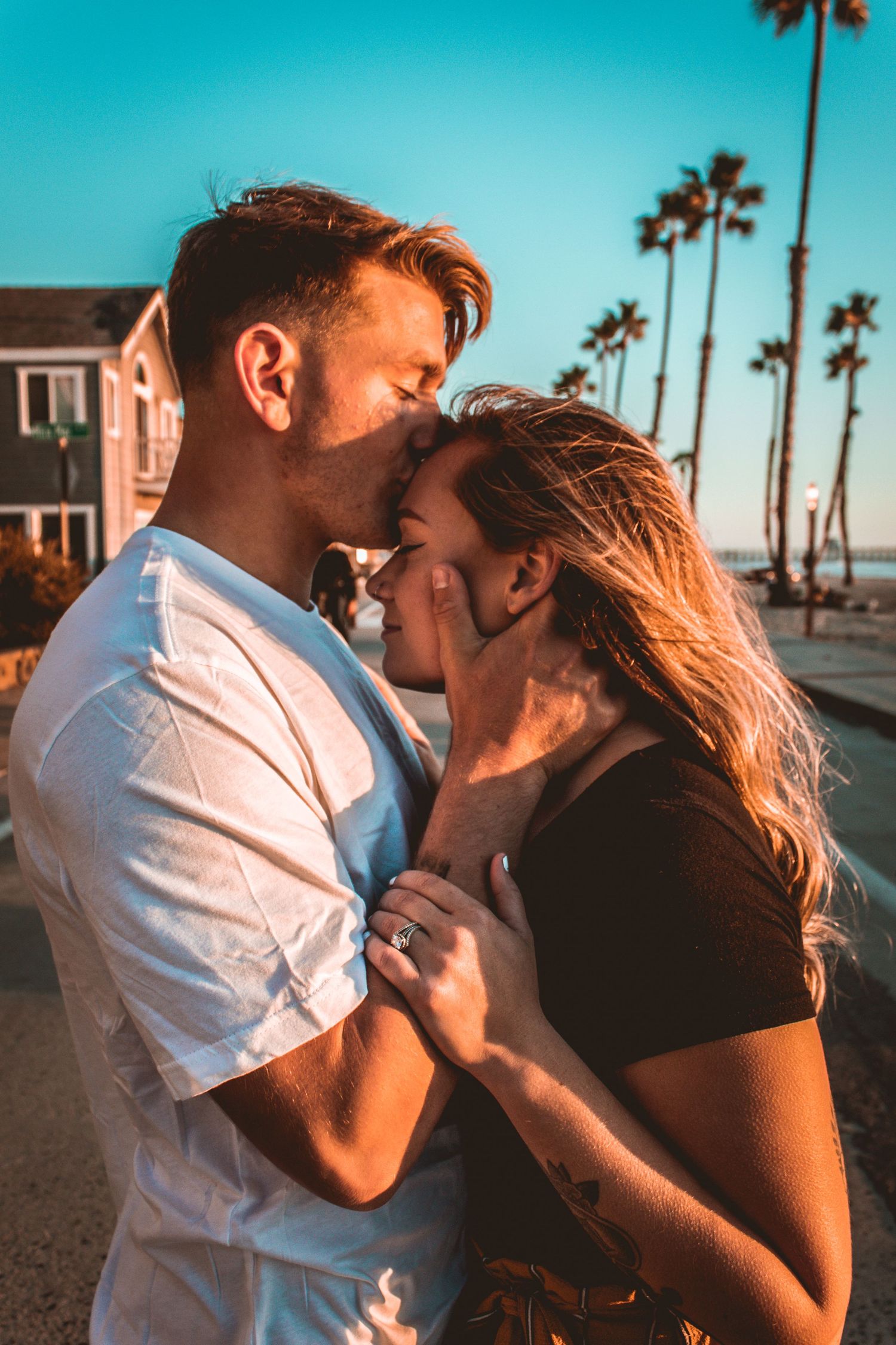 couple posing in the street by the beach in oceanside, ca