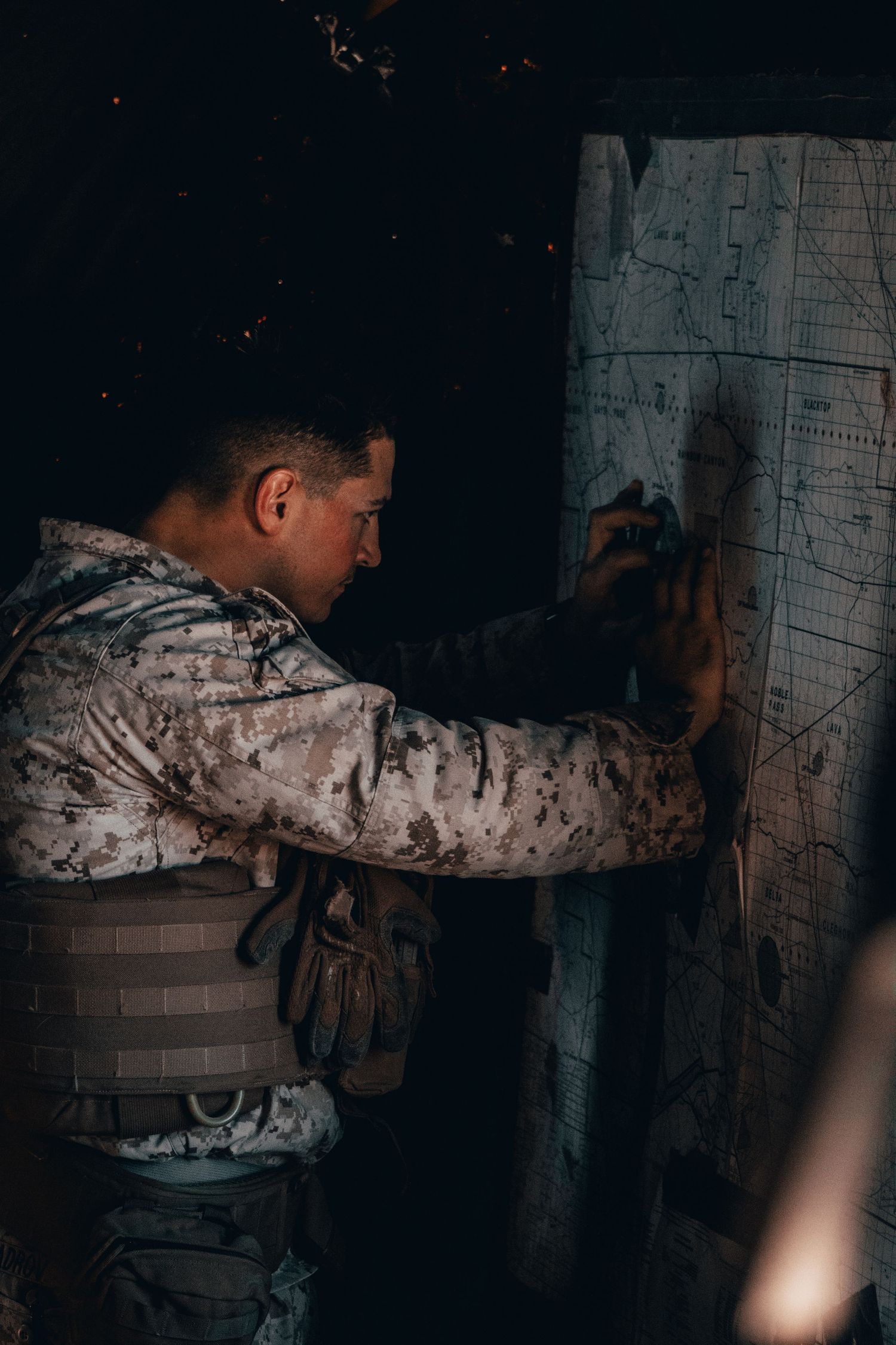 marine looking at map in the field