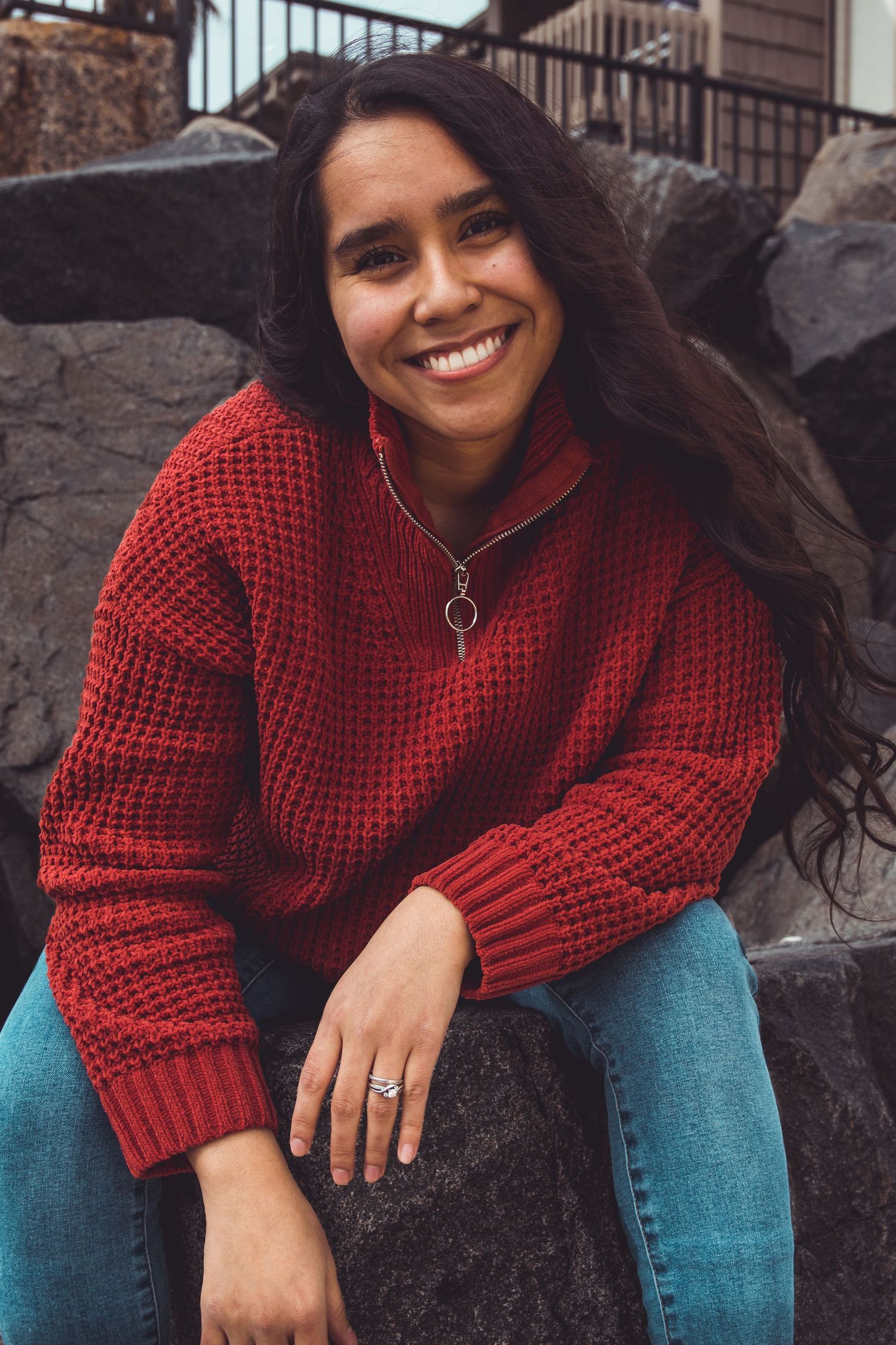 woman posing on rocks near on the beach in oceanside, ca