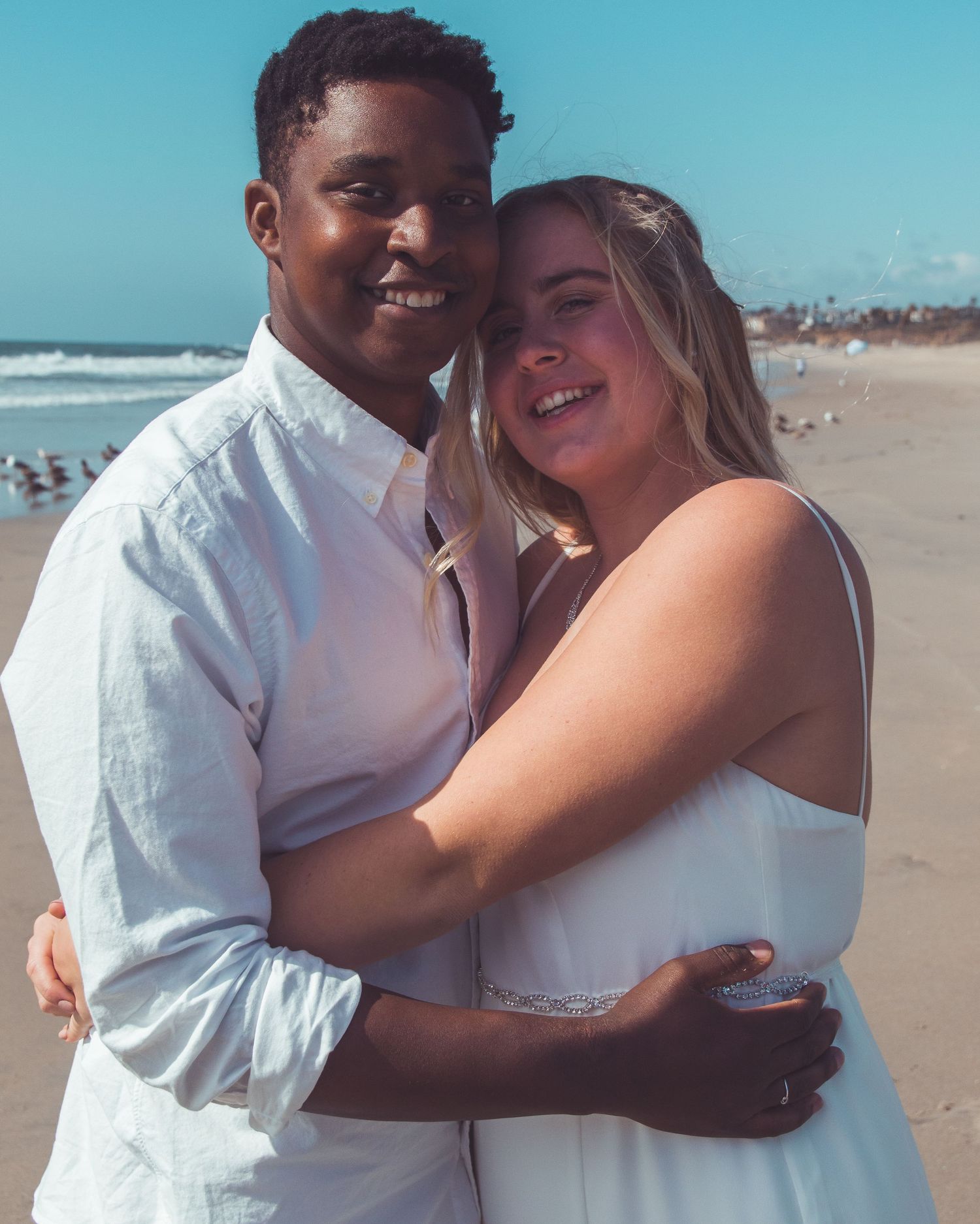 couples posing on beach in carlsbad, ca