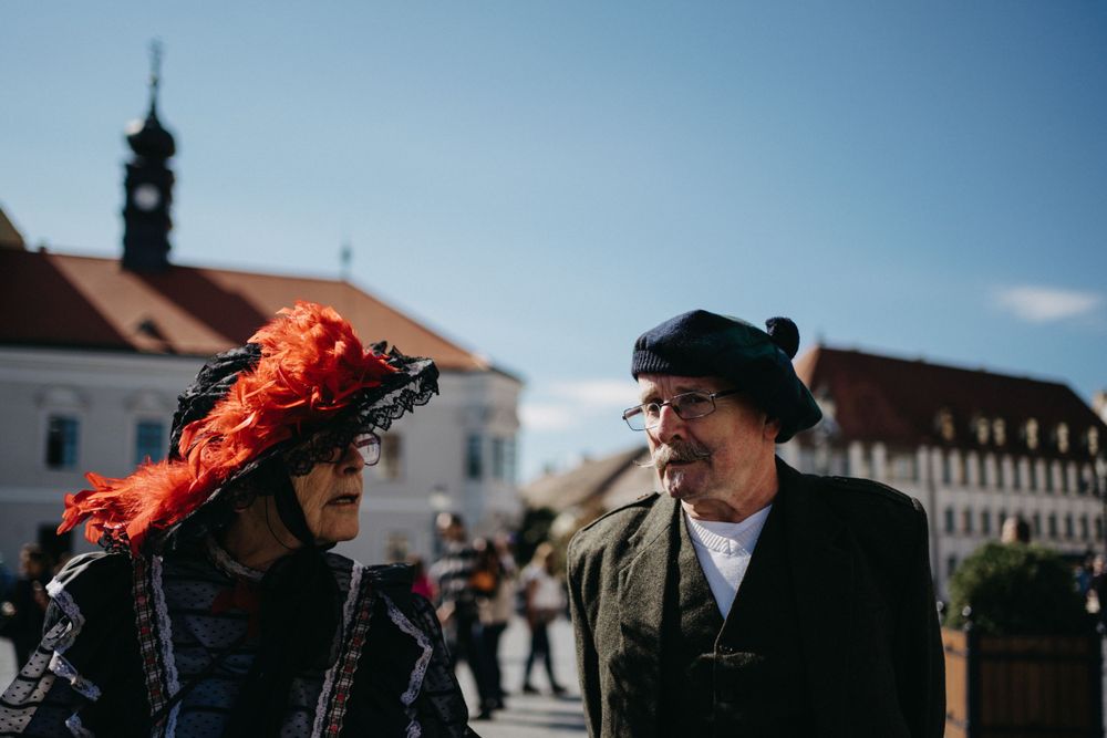 People gathered outdoors on a sunny day with bright blue sky.