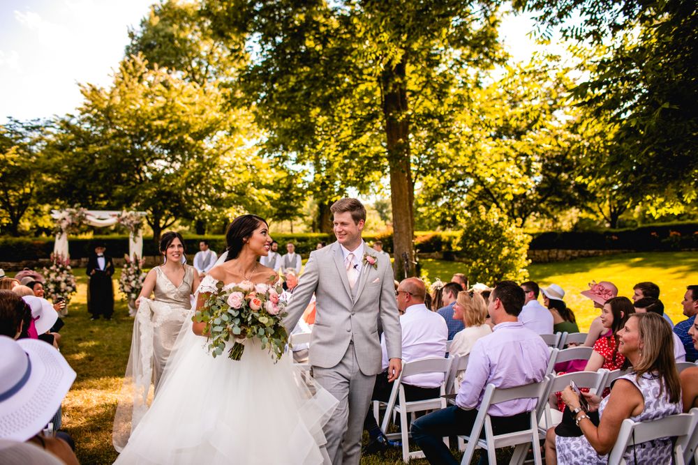 Newlywed exiting their ceremony at Haseltine estates Springfield Missouri by Morgan lea photography