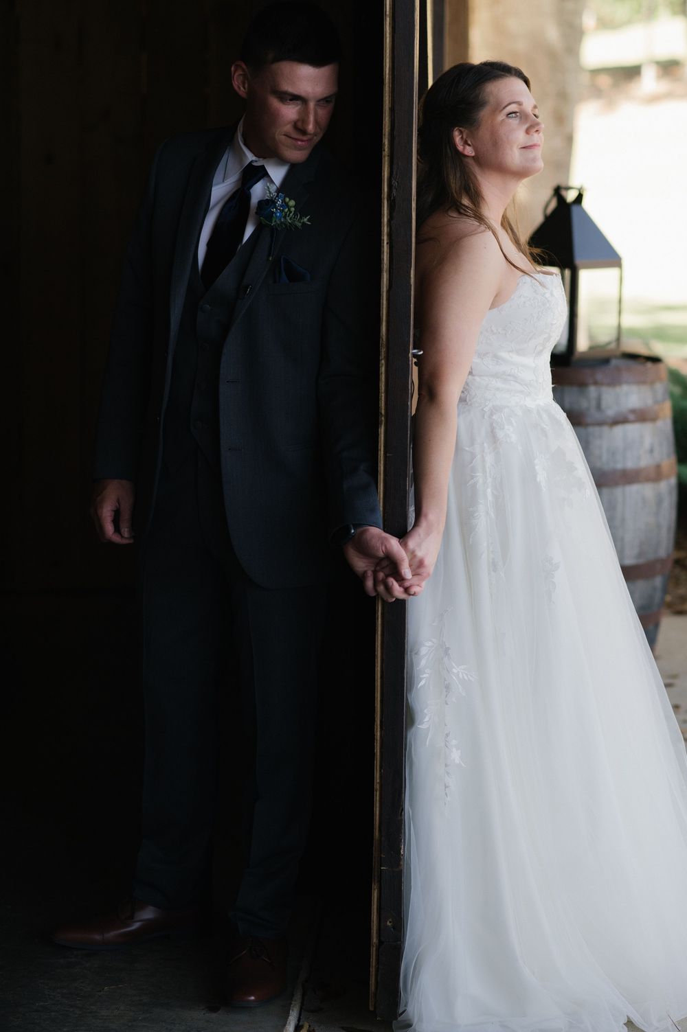 Two people holding hands wearing wedding clothes