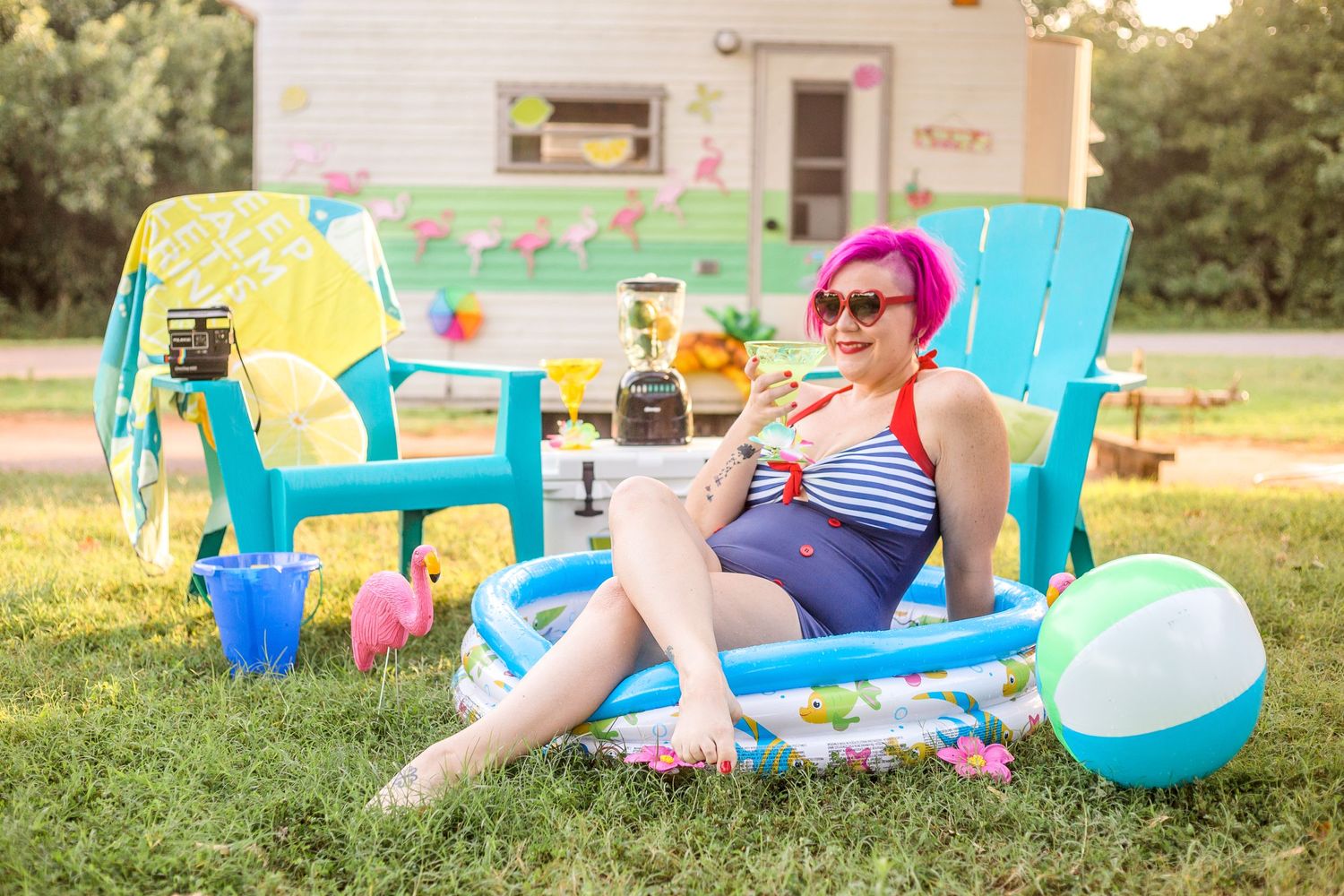 Summer scene with bright chairs and beach toys in a backyard setting.