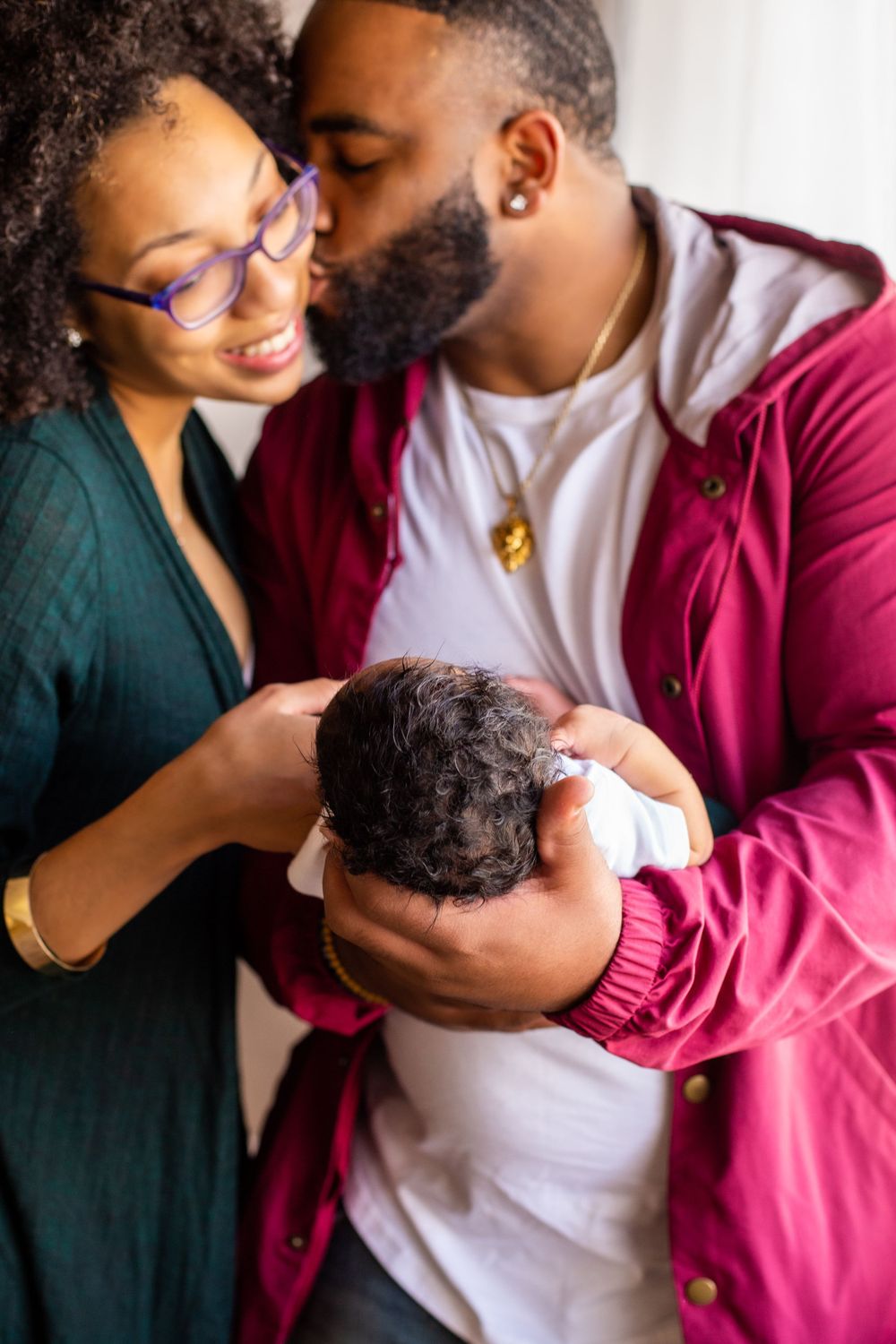 Intimate family moment with newborn baby at home.