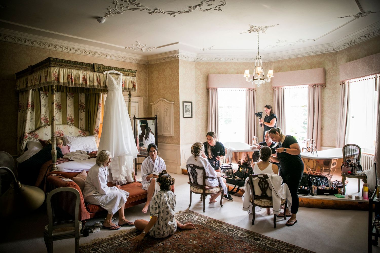 Elegant room with ornate moldings captures wedding day preparation moments.