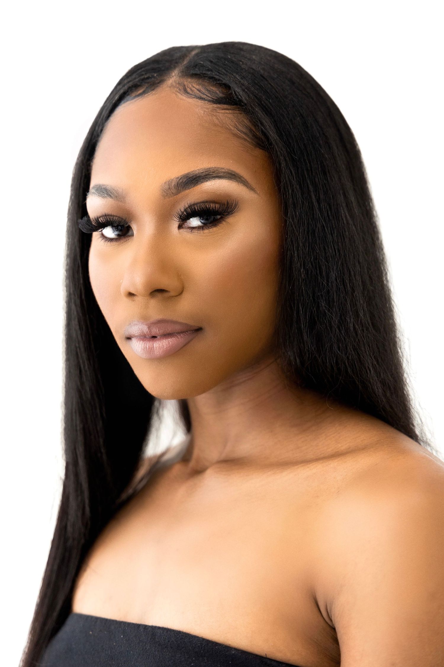 Professional beauty portrait featuring long straight black hair and elegant makeup.