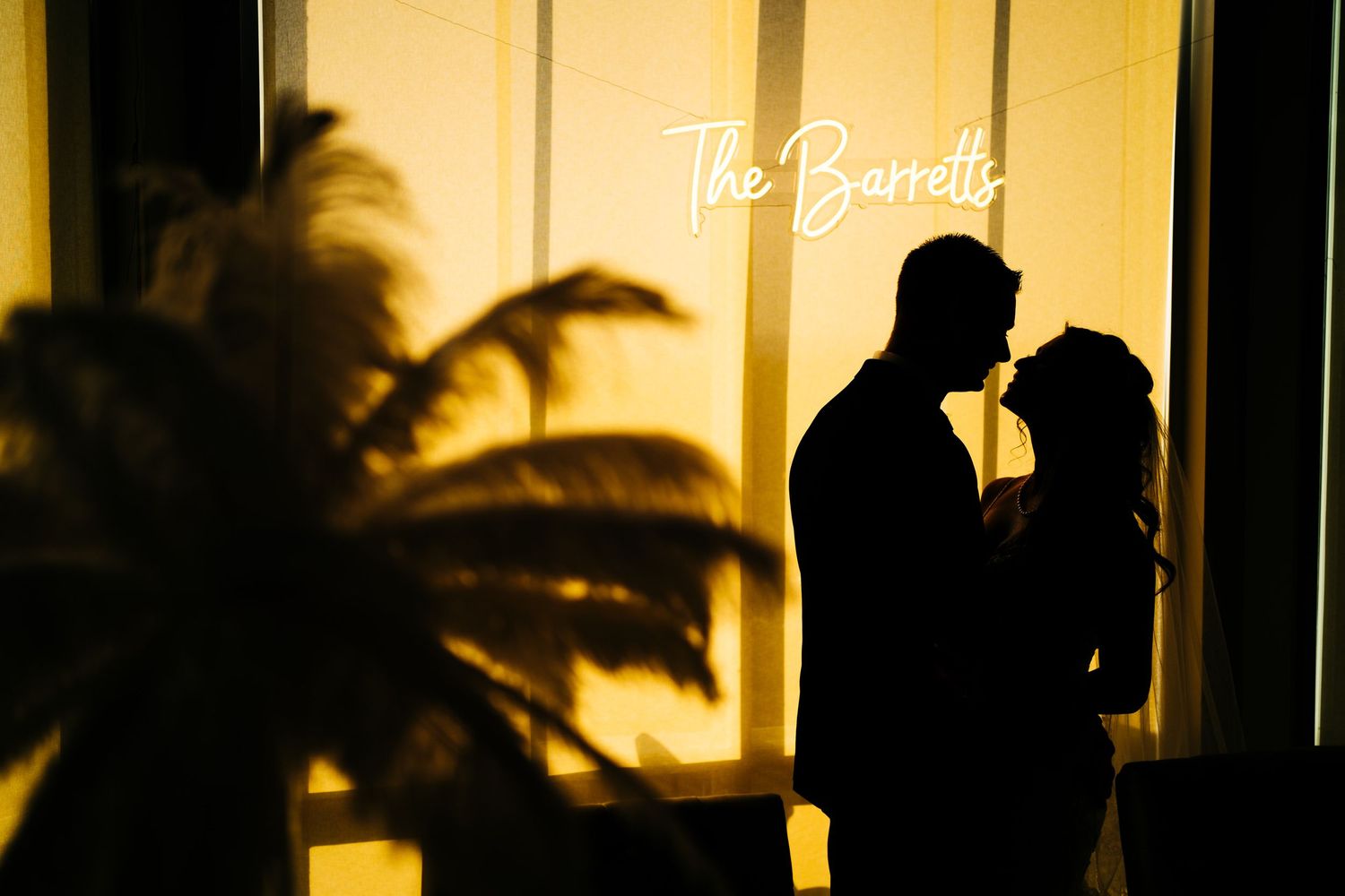 Bride and groom kiss silhouette in orange nj summer wedding