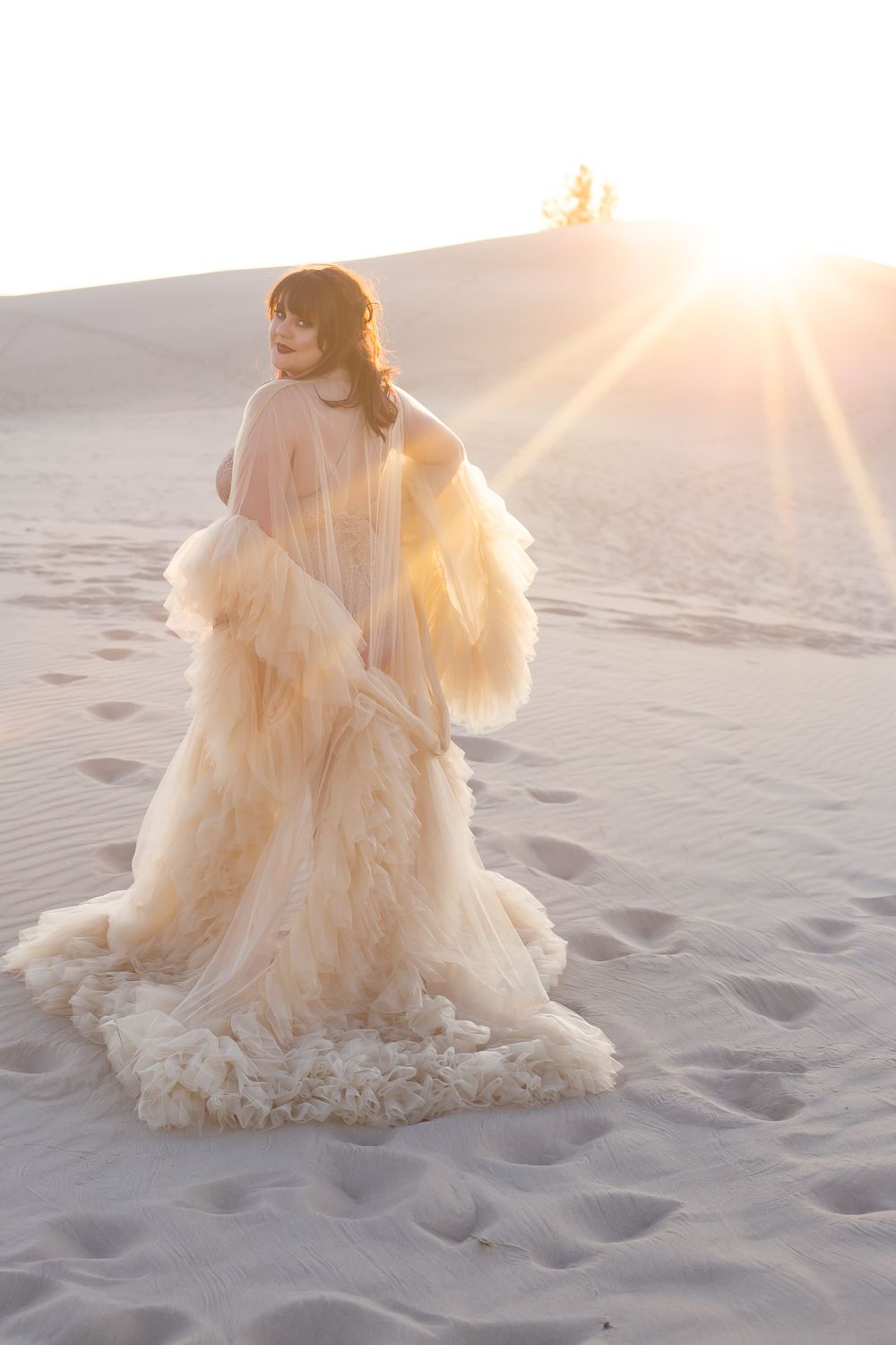 Women in fashion robe in the Sand Dunes at sunset