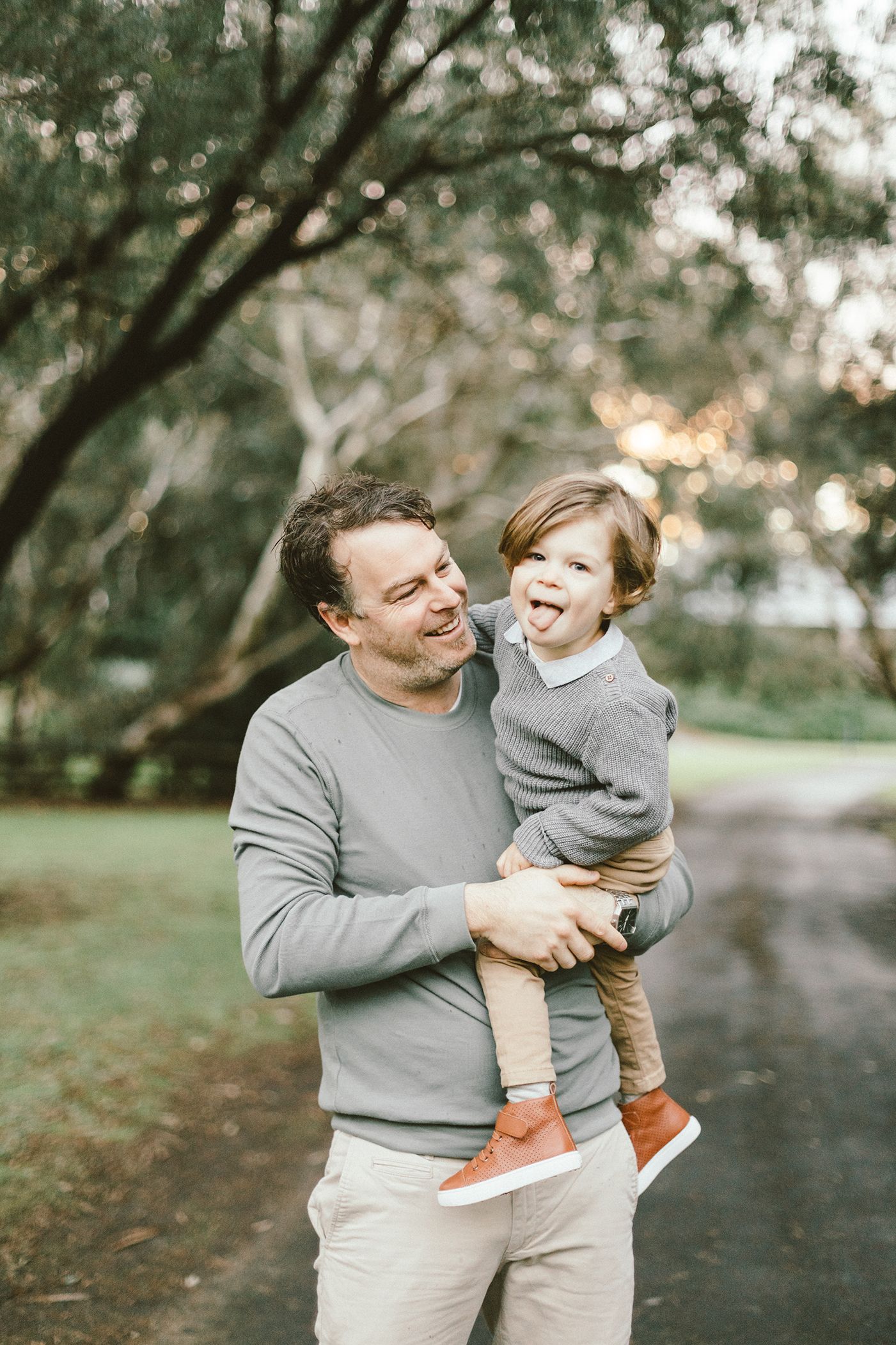 A heartwarming moment between parent and child in a park setting.