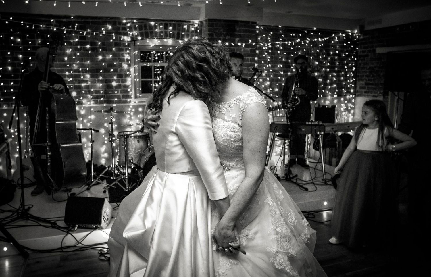 Black and white photo of a tender moment between newlyweds during their first dance.