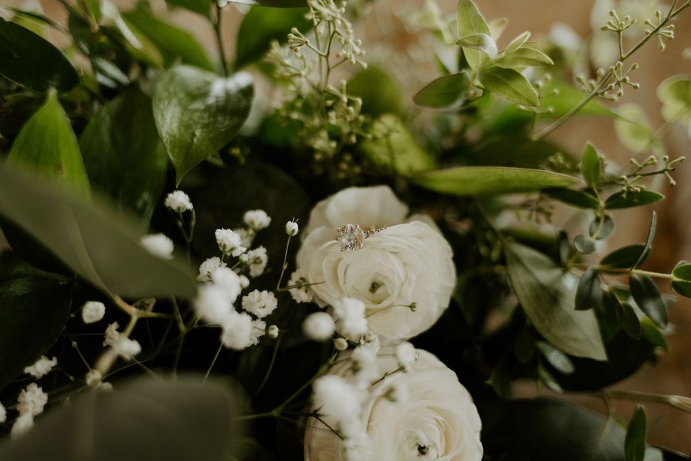 Elegant white roses and baby's breath floral arrangement in soft focus.