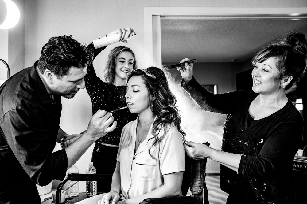 bride having hair and makeup done in hotel room