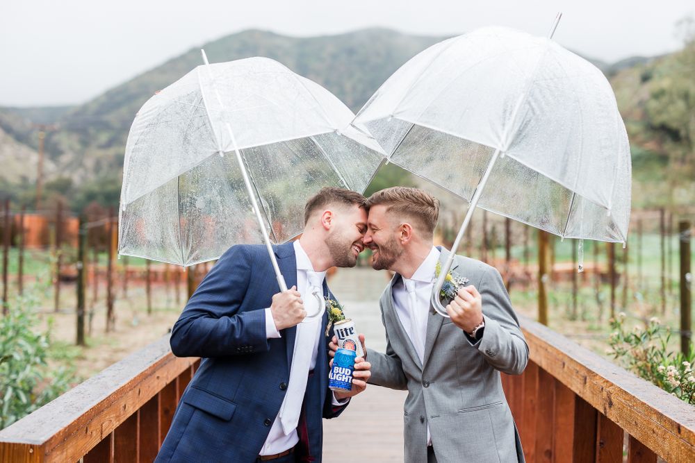 LGBTQ gay men holding umbrellas at reptacular ranch