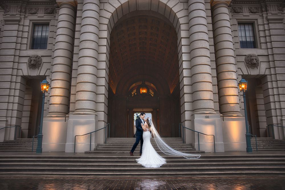 bride and groom standing in front of pasadena city hall