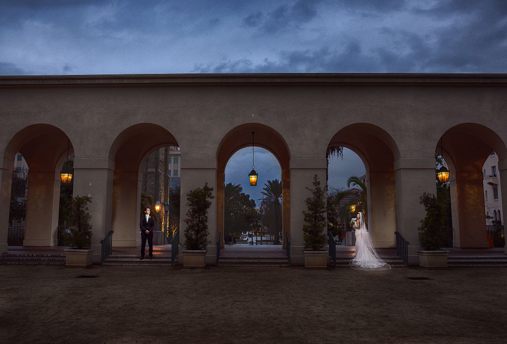 bride and groom standing in archway at the pasadena city hall