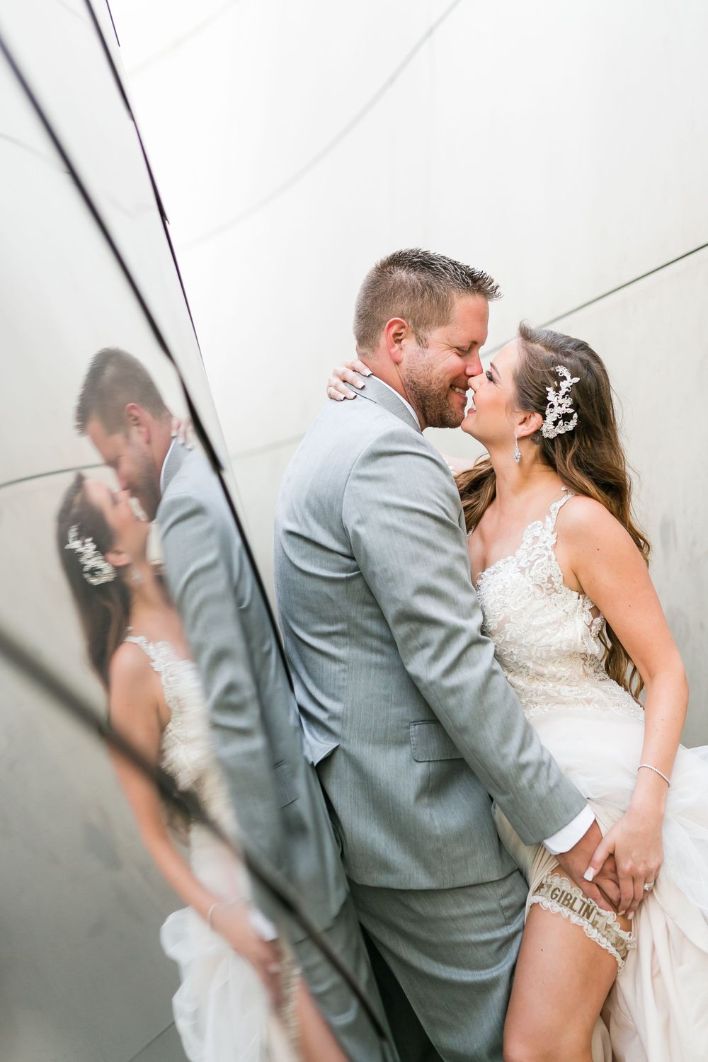 groom holding brides leg showing her garter at disney concert hall