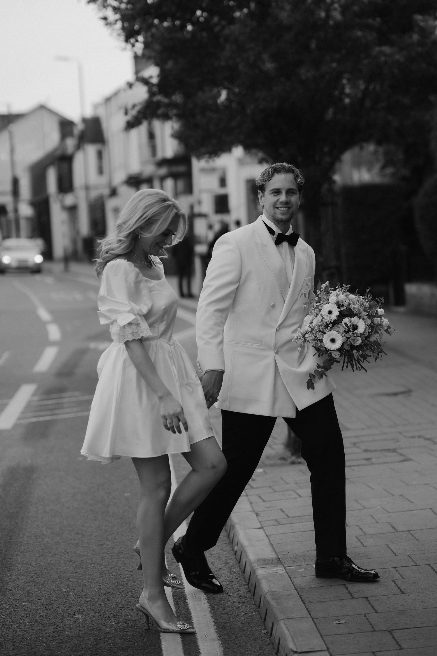 bride and groom walking through oxford